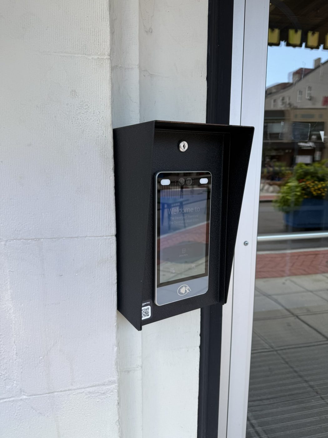 Hooded touchscreen entry reader at an exterior door