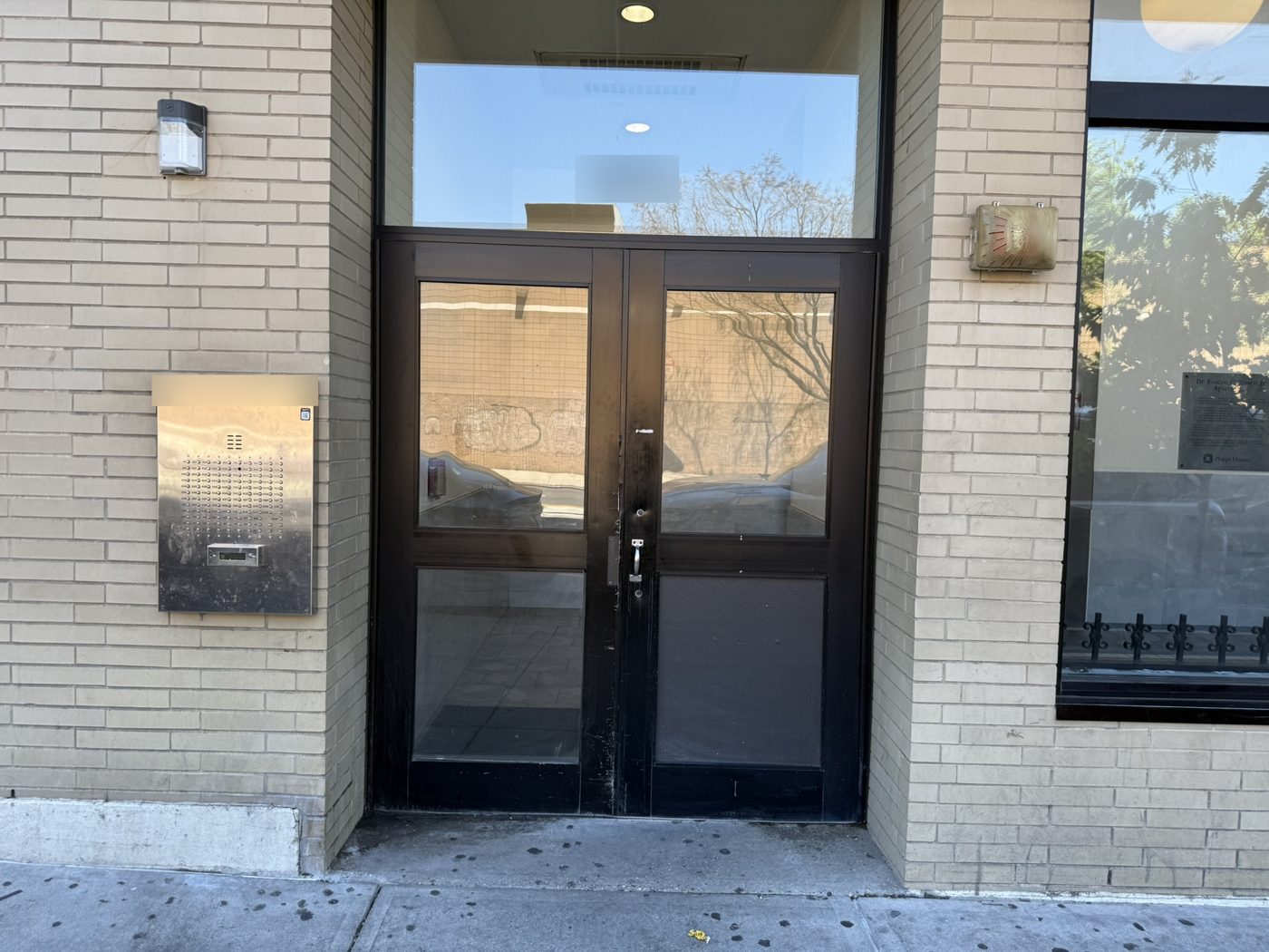 Building entrance with an intercom speaker panel