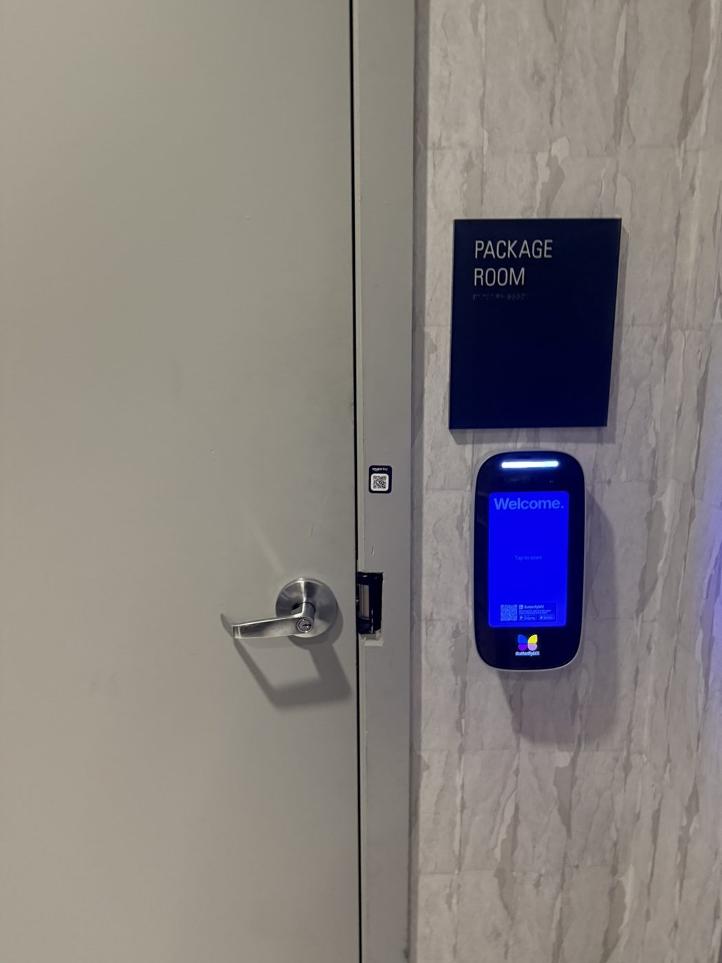 Touchscreen reader beside a package room door